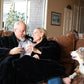 Couple with dog wearing faux fur two person jacket