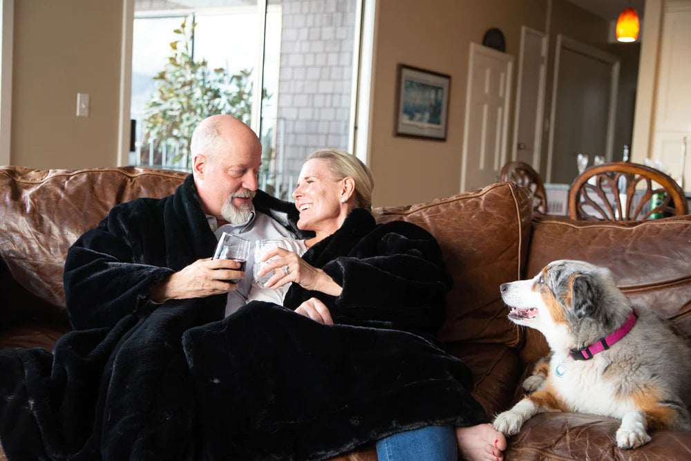 Couple with dog wearing faux fur two person jacket