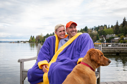 Couple with dog wearing purple and gold fleece jacket