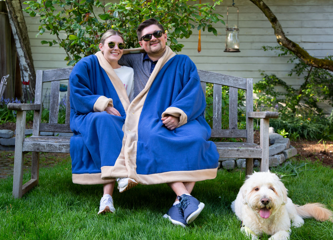 Couple wearing two person blue and tan fleece jacket